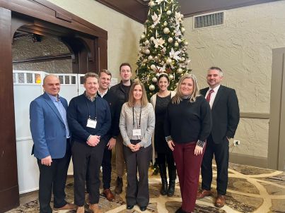 Wespath staff posing in front of a Christmas tree